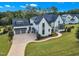 Aerial view of landscaped front yard, long driveway and luxury detailing of exterior elevation at 1633 Estate Valley Ln, Raleigh, NC 27613