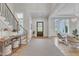 Inviting foyer with hardwood floors, staircase, console table, area rug, and natural light streaming through the front door at 1633 Estate Valley Ln, Raleigh, NC 27613