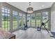 Bright home gym with large windows offering great views of the outdoors at 1633 Estate Valley Ln, Raleigh, NC 27613