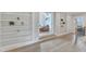 Hallway features hardwood floors and built-in shelving leading to a comfortable seating area at 1633 Estate Valley Ln, Raleigh, NC 27613