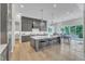 A spacious kitchen with an island, seating, modern appliances, and light wood floors offers space to dine and entertain at 1633 Estate Valley Ln, Raleigh, NC 27613