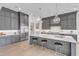 A spacious kitchen with an island, seating, modern appliances, and light wood floors offers space to dine and entertain at 1633 Estate Valley Ln, Raleigh, NC 27613