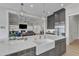 A modern kitchen island with white countertops and sink offers a view into the living area and fireplace at 1633 Estate Valley Ln, Raleigh, NC 27613