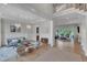 Bright living room with hardwood floors, stylish chandeliers, and an open layout connecting to the adjacent sitting area at 1633 Estate Valley Ln, Raleigh, NC 27613