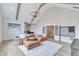 Comfortable living area showcases beamed ceilings, leather sofa, and access to a wet bar at 1633 Estate Valley Ln, Raleigh, NC 27613