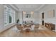 Elegant living room featuring hardwood floors, designer chandeliers, large windows, and a modern color palette at 1633 Estate Valley Ln, Raleigh, NC 27613