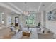 Beautifully designed living room with hardwood floors, elegant lighting, and a seamless transition to a staircase at 1633 Estate Valley Ln, Raleigh, NC 27613