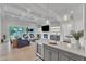 Open-concept living room flows into the kitchen, featuring a fireplace, coffered ceilings, and lots of light at 1633 Estate Valley Ln, Raleigh, NC 27613