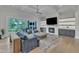 Spacious living room with fireplace, large windows, comfortable seating, and stylish rug at 1633 Estate Valley Ln, Raleigh, NC 27613