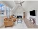 Light-filled living room with hardwood floors, two leather chairs, and comfortable seating at 1633 Estate Valley Ln, Raleigh, NC 27613
