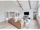 Spacious living room with beamed ceiling, hardwood flooring, and a cozy leather sofa at 1633 Estate Valley Ln, Raleigh, NC 27613