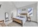 Bright, modern main bedroom with large windows, a bed and bedside tables, and an ensuite bath at 1633 Estate Valley Ln, Raleigh, NC 27613
