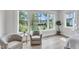 Bright sitting area with a serene view outside the large window and two chairs at 1633 Estate Valley Ln, Raleigh, NC 27613