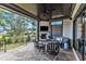 Cozy covered outdoor living space with stone floors, a fireplace, and comfortable seating at 1633 Estate Valley Ln, Raleigh, NC 27613