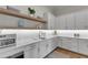 A functional pantry space boasts white countertops, ample cabinet space, a sink and appliances for food preparation at 1633 Estate Valley Ln, Raleigh, NC 27613