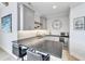 Stylish wet bar area featuring gray cabinets, granite countertop, and a beverage refrigerator at 1633 Estate Valley Ln, Raleigh, NC 27613