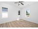 Bright bedroom with hardwood floors, neutral paint, a ceiling fan, and natural light from windows at 19 Southern Village Dr, Roxboro, NC 27573