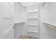 Walk-in closet with built-in shelving and rod for hanging clothes at 19 Southern Village Dr, Roxboro, NC 27573