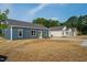 Exterior shot of a blue single story home featuring well-manicured lawns at 19 Southern Village Dr, Roxboro, NC 27573
