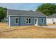 Side view of single story home featuring minimalist landscaping at 19 Southern Village Dr, Roxboro, NC 27573