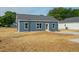 View of single story home featuring a concrete driveway and minimalist landscaping at 19 Southern Village Dr, Roxboro, NC 27573