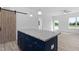 Kitchen island with granite countertops and navy cabinetry, open to a living area with natural light at 19 Southern Village Dr, Roxboro, NC 27573