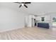 Open concept living area flows into the kitchen with white cabinets and a navy kitchen island at 19 Southern Village Dr, Roxboro, NC 27573