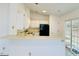 Functional kitchen with white cabinets, modern appliances, and a convenient breakfast bar at 203 Standish Dr, Chapel Hill, NC 27517