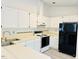 Well-lit kitchen area featuring a combination of white cabinets and appliances at 203 Standish Dr, Chapel Hill, NC 27517