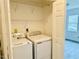 Convenient laundry room featuring washer and dryer, with shelving at 203 Standish Dr, Chapel Hill, NC 27517