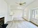 Open concept living room with a vaulted ceiling, fireplace, and wood flooring at 203 Standish Dr, Chapel Hill, NC 27517