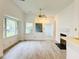 Bright living room with wood flooring, a fireplace, and large windows for natural light at 203 Standish Dr, Chapel Hill, NC 27517