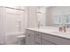 Well-lit bathroom featuring dual sinks with modern fixtures, a bathtub with shower, and bright, airy at 2089 Florine Dr, Apex, NC 27502