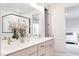 Well-lit bathroom with double vanity, a decorative mirror, and a view of the glass shower from the open doorway at 2089 Florine Dr, Apex, NC 27502
