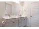 Bathroom featuring a large mirror above dual sinks, complemented by modern fixtures and cabinetry at 2089 Florine Dr, Apex, NC 27502