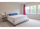 Bright bedroom featuring a comfortable bed, with a blue lumbar pillow, side tables, and natural light from a window at 2089 Florine Dr, Apex, NC 27502