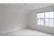 Bedroom featuring a window, neutral carpet, and a closet at 2089 Florine Dr, Apex, NC 27502