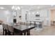 Open concept dining and living room with hardwood floors and modern light fixtures at 2089 Florine Dr, Apex, NC 27502