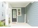 Inviting front porch with a black door and 'Welcome' sign at 2089 Florine Dr, Apex, NC 27502