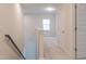 Bright hallway with neutral walls and carpet leading to a sunlit room with a window at 2089 Florine Dr, Apex, NC 27502