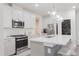 Modern kitchen with white cabinets, stainless steel appliances, and an island at 2089 Florine Dr, Apex, NC 27502