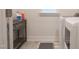 Functional laundry room with washer, dryer, storage table, and a window for natural light at 2089 Florine Dr, Apex, NC 27502