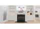 Cozy living room with a fireplace, built-in shelving, and a flatscreen television at 2089 Florine Dr, Apex, NC 27502