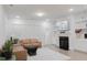 Bright living room features tan leather couches, fireplace and hardwood floors at 2089 Florine Dr, Apex, NC 27502