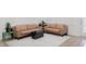 Bright living room features tan leather couches, fireplace and hardwood floors at 2089 Florine Dr, Apex, NC 27502