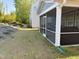 A charming screened-in porch enhances outdoor living, seamlessly connecting to a green yard and a comfortable home environment at 2089 Florine Dr, Apex, NC 27502