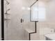 Modern shower with marble-style tile, glass enclosure, built-in bench, and a showerhead at 2089 Florine Dr, Apex, NC 27502