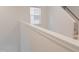 Bright staircase featuring white walls and a natural wood handrail at 2089 Florine Dr, Apex, NC 27502