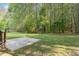 Spacious backyard with a concrete slab for playing basketball and beautiful green grass at 2112 Ballston Pl, Knightdale, NC 27545