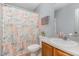 Compact bathroom with a nautical-themed shower curtain and a wood-finished vanity at 2112 Ballston Pl, Knightdale, NC 27545